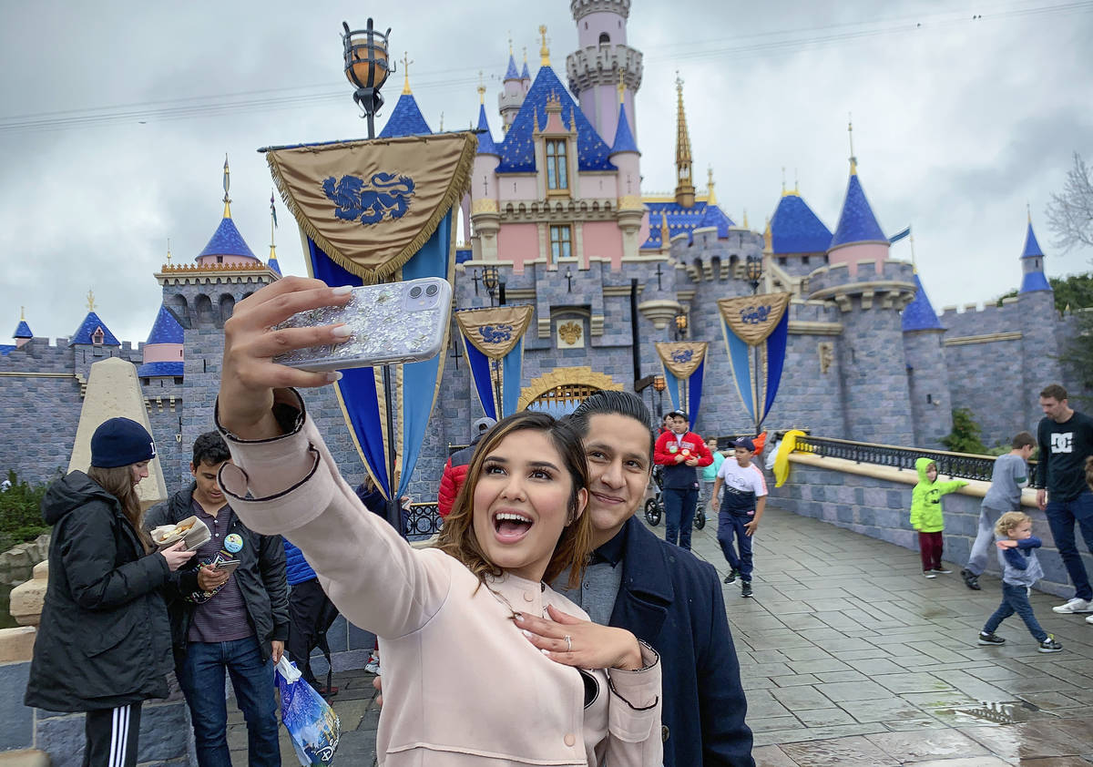 In this March 13, 2020, file photo, Katherine Quezada shows off her engagement ring as she take ...