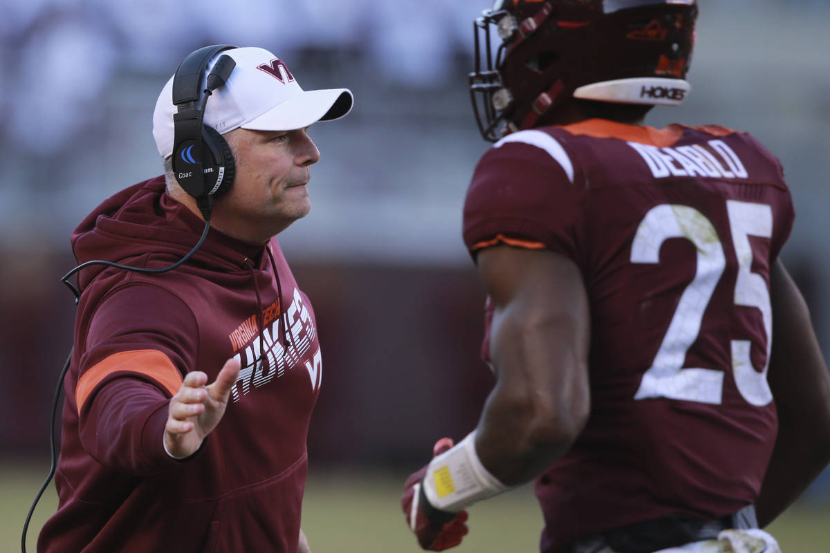 Virginia Tech head coach Justin Fuente greets Virginia Tech Defensive Back Divine Deablo (25) d ...