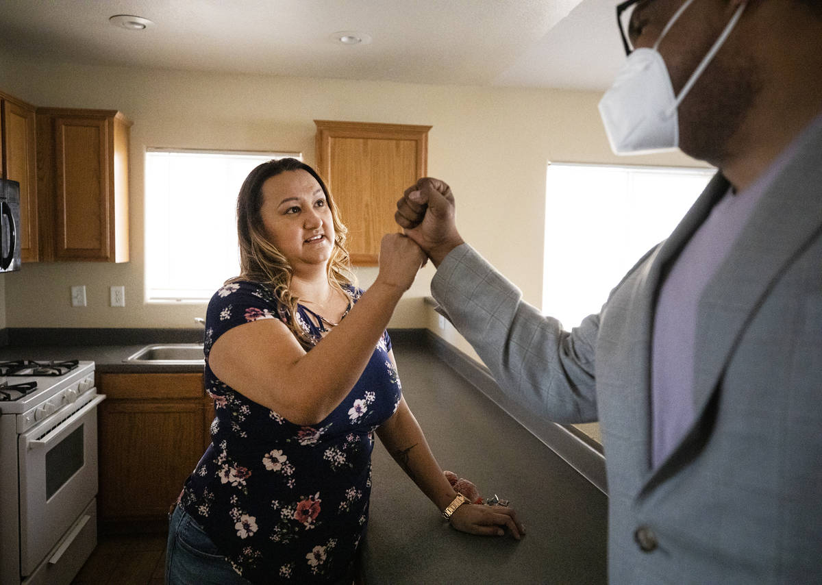 First-time homebuyer Amy Phinsee, left, fist bumps realtor Cassidy Cotten, right, at a showing ...