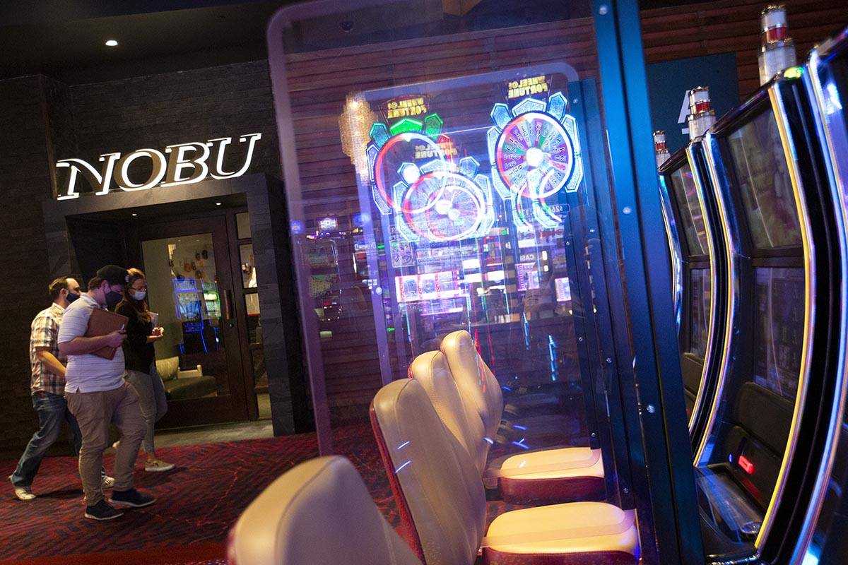 People walk past Nobu and the Mohegan Sun Casino floor at Virgin Hotels Las Vegas on Friday, Ap ...
