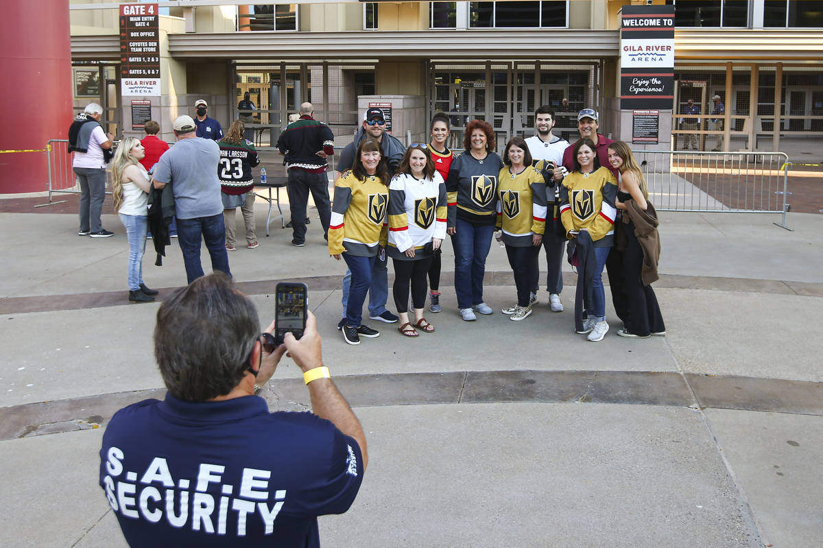 Golden Knights fans pose for a photo before the start of an NHL hockey game against the Arizona ...