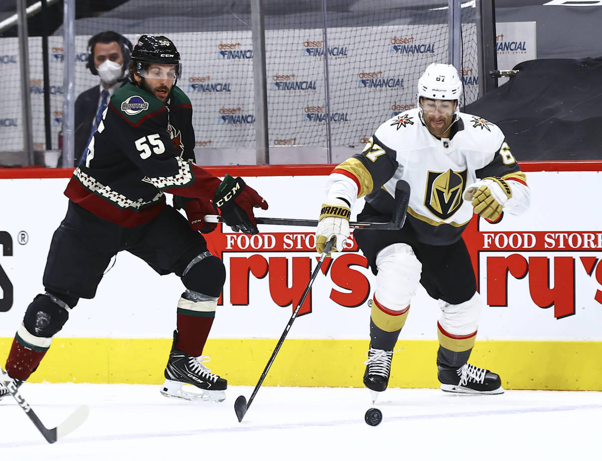 Golden Knights' Max Pacioretty (67) reaches out for the puck under pressure from Arizona Coyote ...