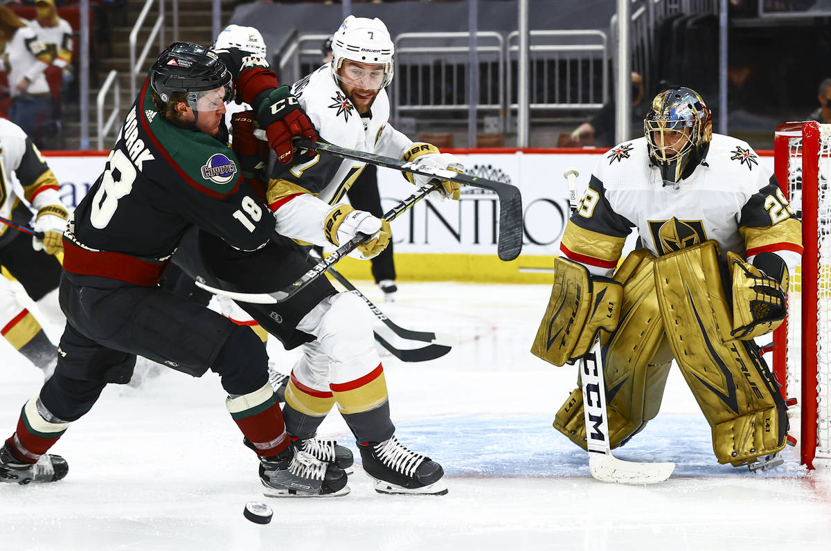 Golden Knights goaltender Marc-Andre Fleury (29) watches a rebound as Arizona Coyotes' Christia ...