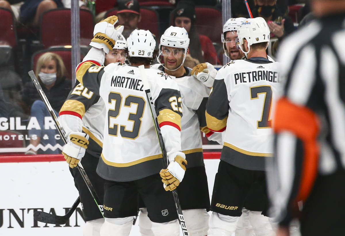 Golden Knights' Mark Stone, fourth from left, celebrates his goal with teammates, including Max ...