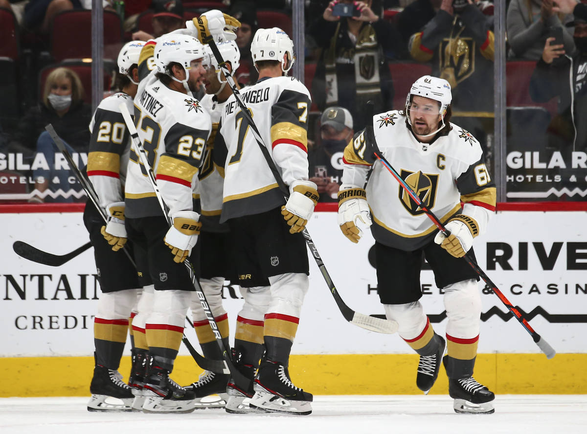 Golden Knights' Mark Stone, right, looks on after his goal against the Arizona Coyotes during t ...