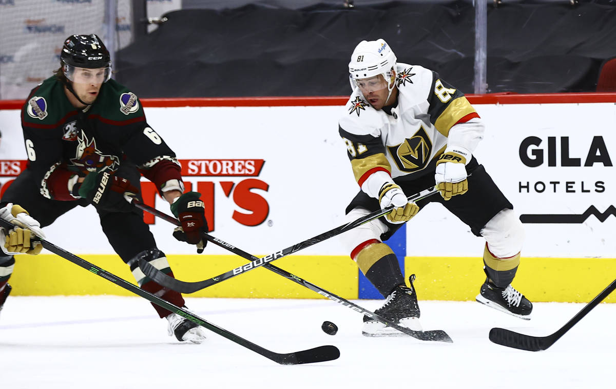 Arizona Coyotes' Jakob Chychrun (6) and Golden Knights' Jonathan Marchessault (81) vie for the ...