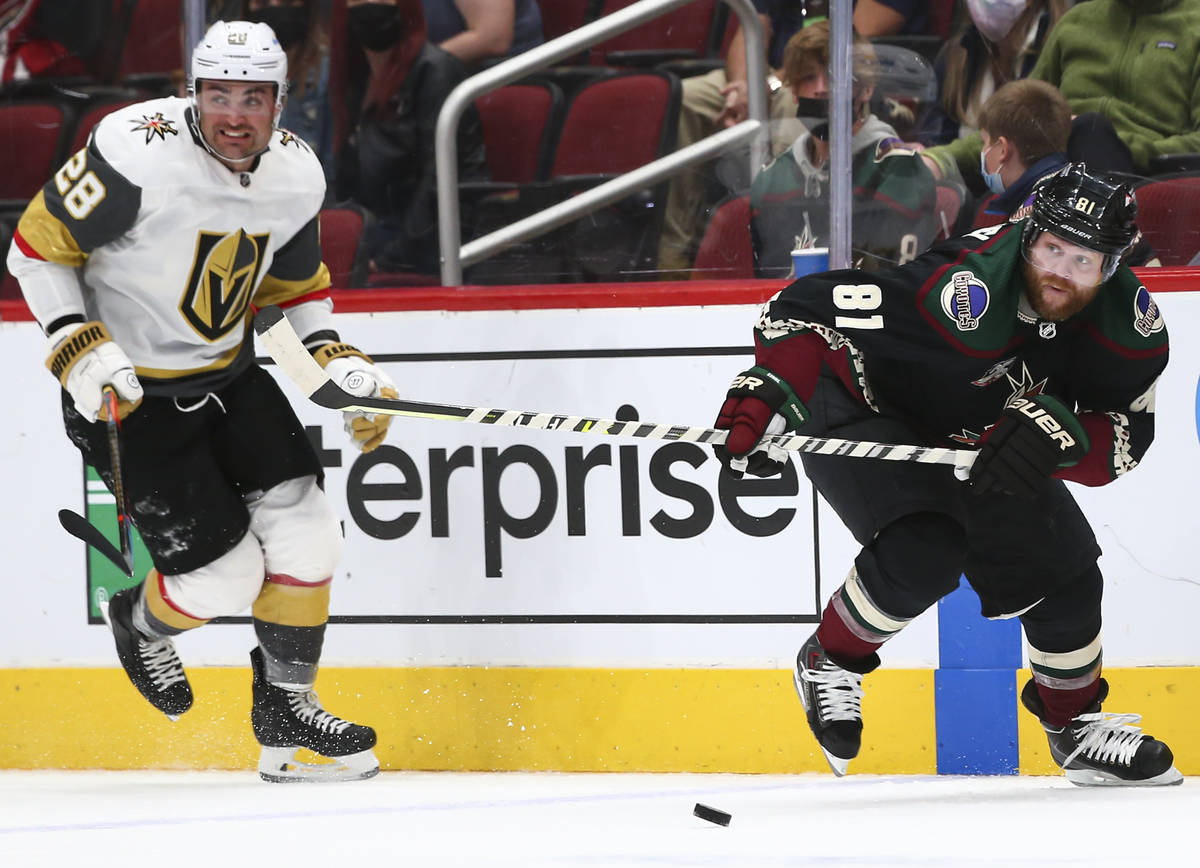 Arizona Coyotes' Phil Kessel (81) skates after the puck under pressure from Golden Knights' Wil ...