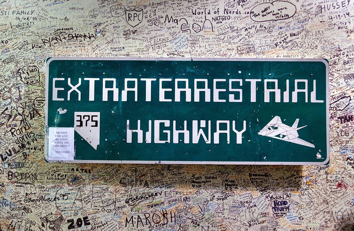 One of the Extraterrestrial Highway signs hangs about graffiti in the Alien Research Center whi ...