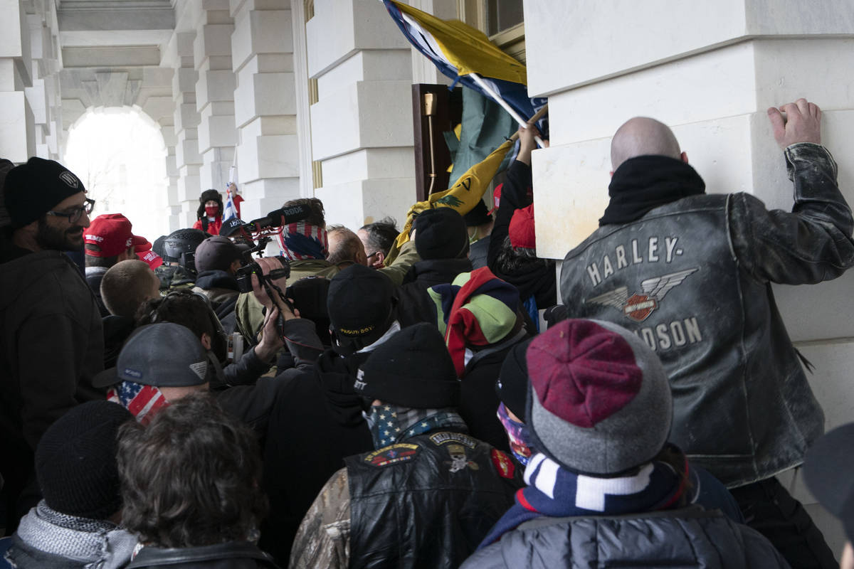 In this Jan. 6, 2021 file photo insurrectionists loyal to President Donald Trump try to open a ...