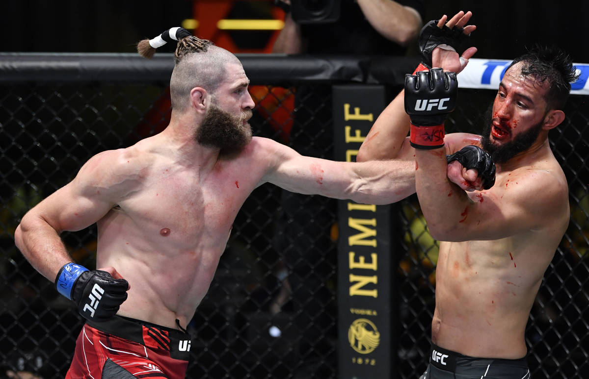 Jiri Prochazka of the Czech Republic, left, punches Dominick Reyes in a light heavyweight bout ...