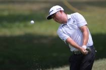 David Lipsky of the United States chip to the green on the 18th hole at the Malaysia Golf Champ ...