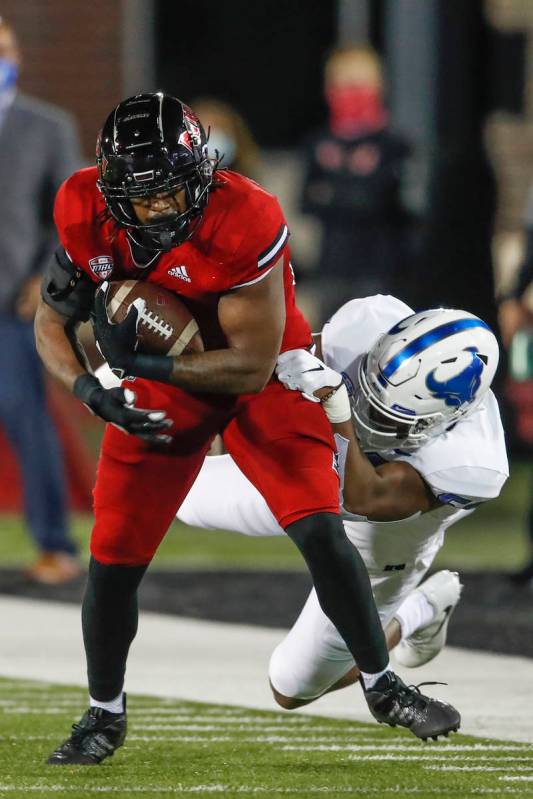 Northern Illinois Huskies tight end Daniel Crawford (88) is tackled by Buffalo Bulls defensive ...