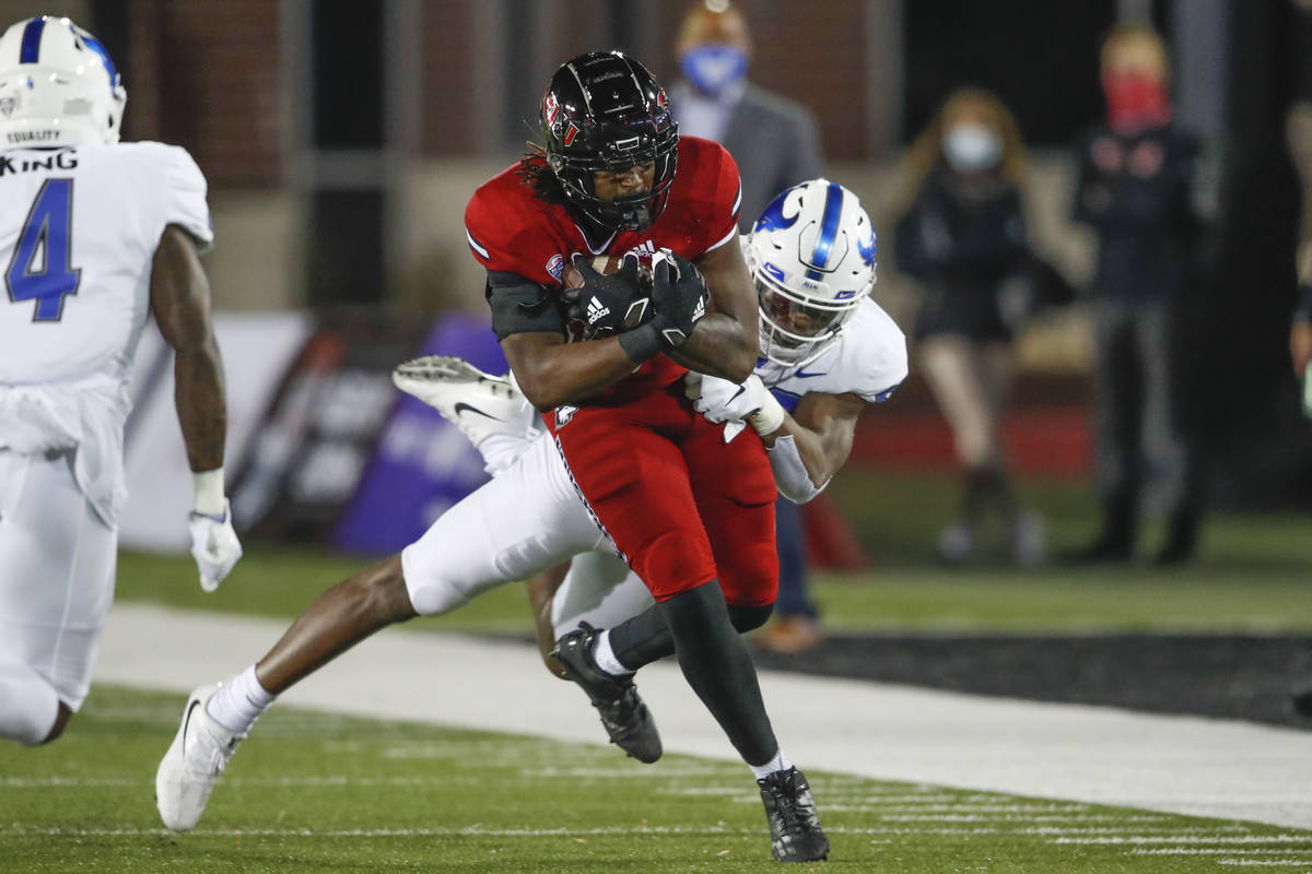 Northern Illinois Huskies tight end Daniel Crawford (88) is tackled by Buffalo Bulls defensive ...