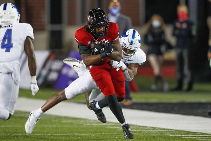 Northern Illinois Huskies tight end Daniel Crawford (88) is tackled by Buffalo Bulls defensive ...
