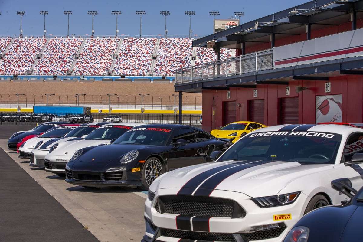 Race cars are lined up outside of Dream Racing as UNLV coaches bring their Rebel Caravan to the ...