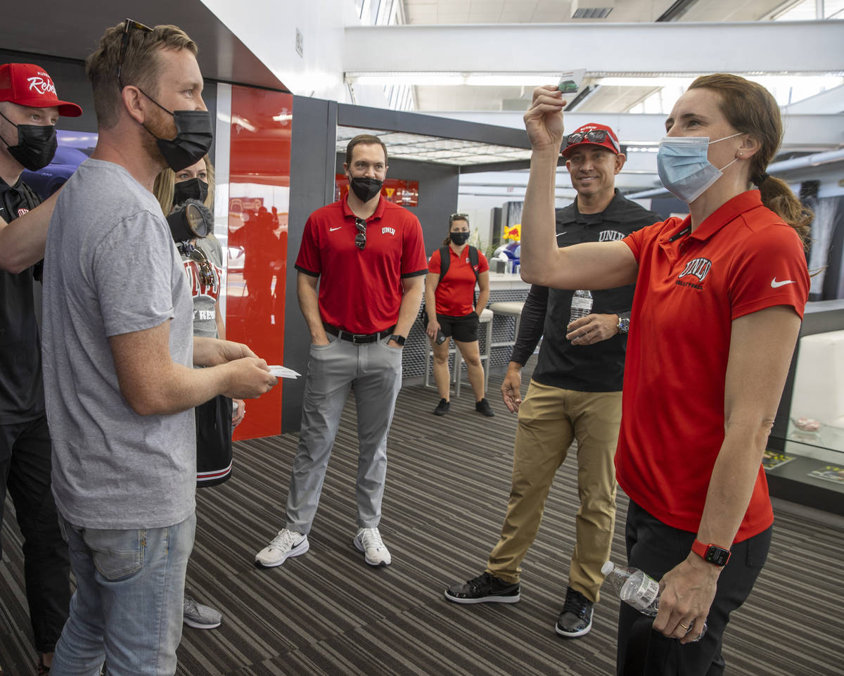 UNLV head volleyball coach Dawn Sullivan, right, reacts to drawing a green Lamborghini to drive ...