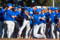 Bishop Gorman rallies around their teammate Maddox Riske (2), center left, after his hit scored ...