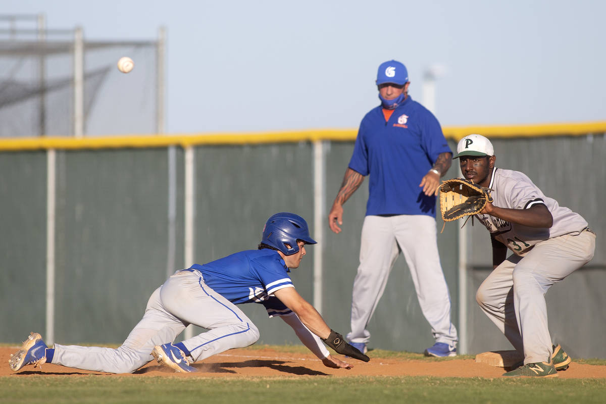 Bishop Gorman's center fielder Santino Panaro (13) slides into first after attempting to steal ...