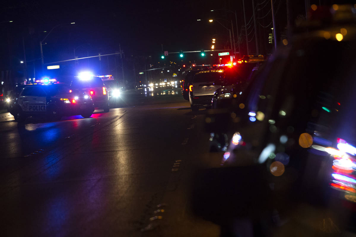 Metropolitan police squad cars line East Charleston Boulevard while police investigate a scene ...
