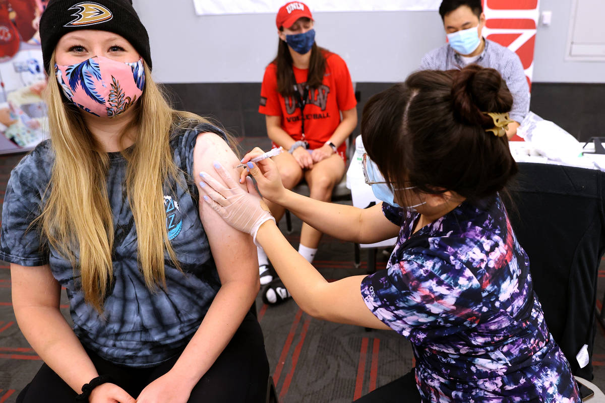 Kassidi Ziegenhagen, 20, of Henderson gets a COVID-19 vaccination from Deanna Chea of UNLV Medi ...