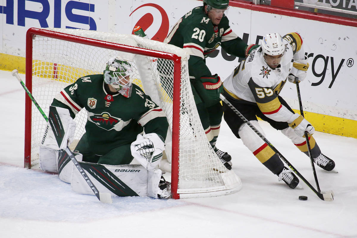 Vegas Golden Knights right wing Keegan Kolesar (55) brings the puck around the goal as Minnesot ...