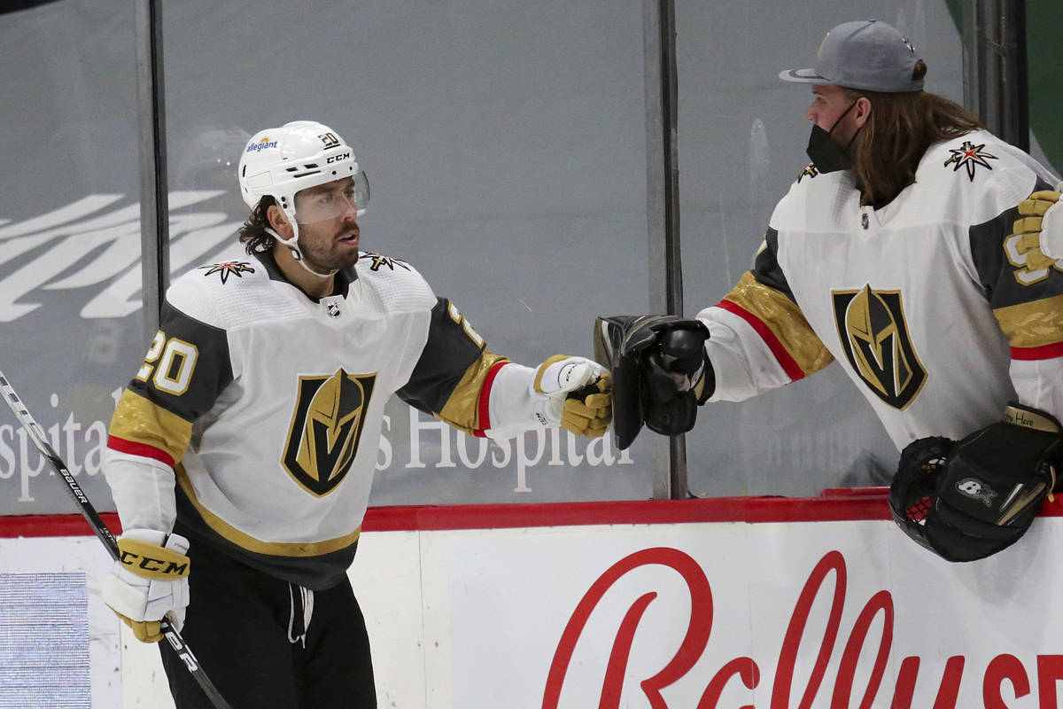 Vegas Golden Knights center Chandler Stephenson (20) is congratulated by goaltender Robin Lehne ...