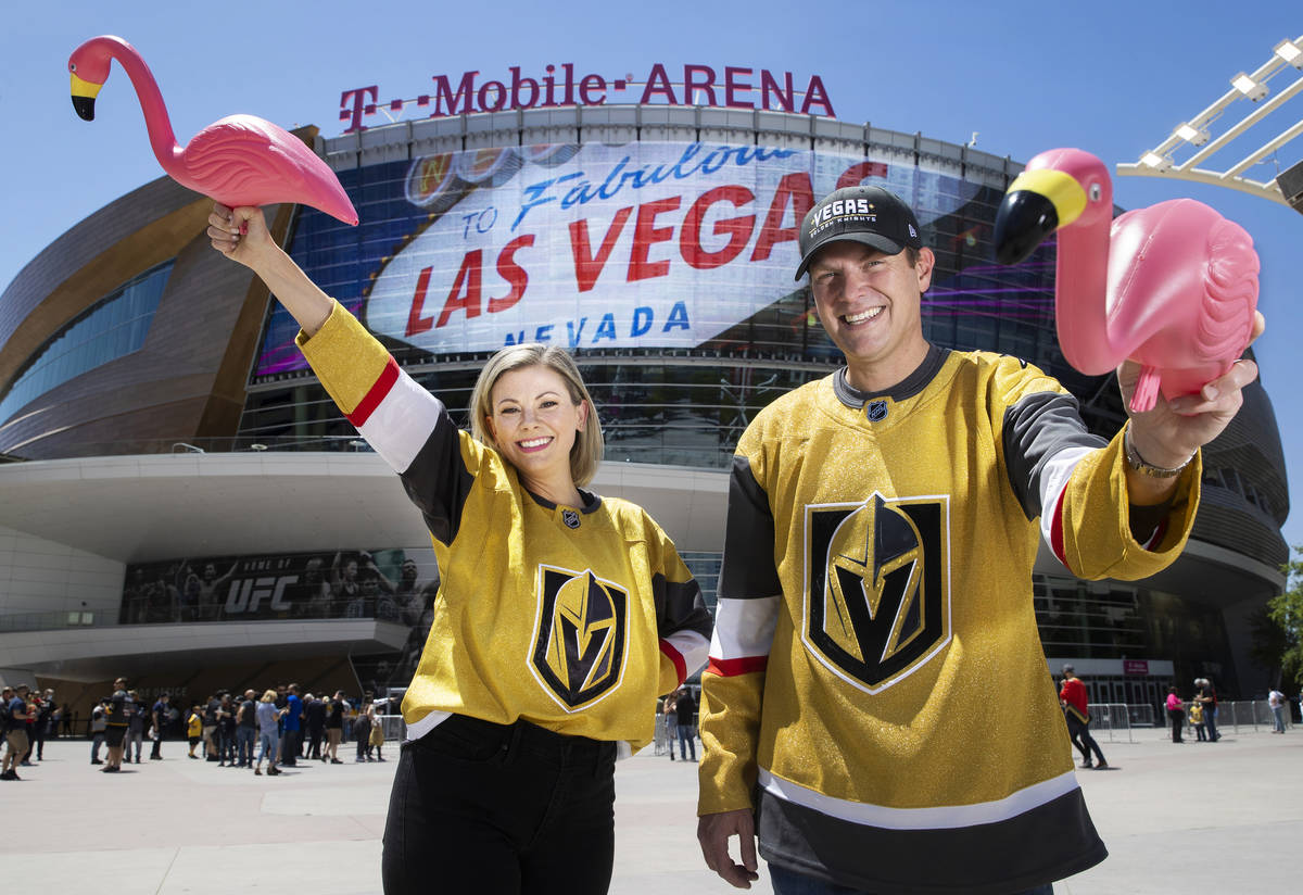 Drew Johnson, right, and wife Sarah, hold plastic flamingo’s outside T-Mobile Arena on S ...