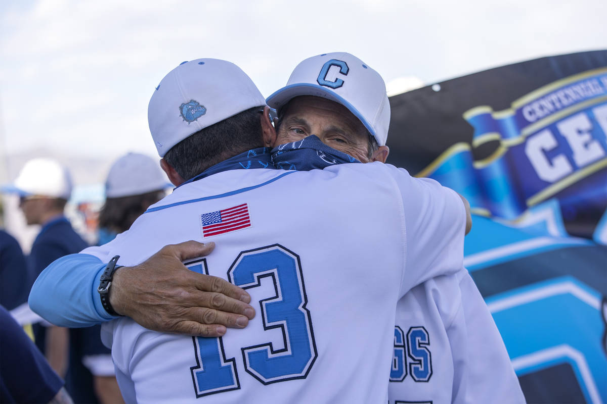Centennial High School's baseball coach Charlie Cerrone hugs his assistant coach Brock Howard a ...