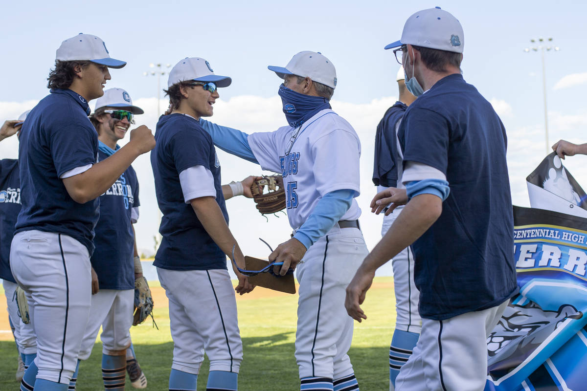 Centennial High School's baseball coach Charlie Cerrone reaches to hug senior Dominic Perez aft ...