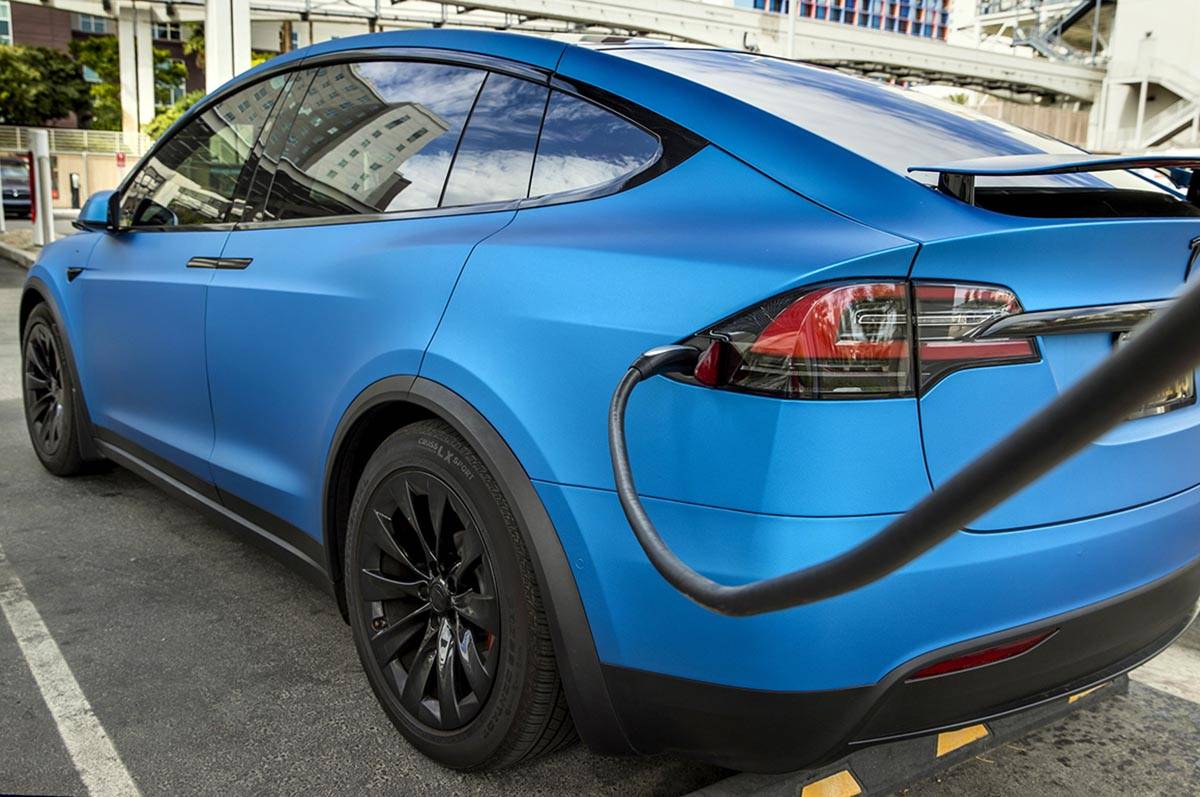A car is plugged in at the Tesla Supercharger station near The LINQ and High Roller on Friday, ...