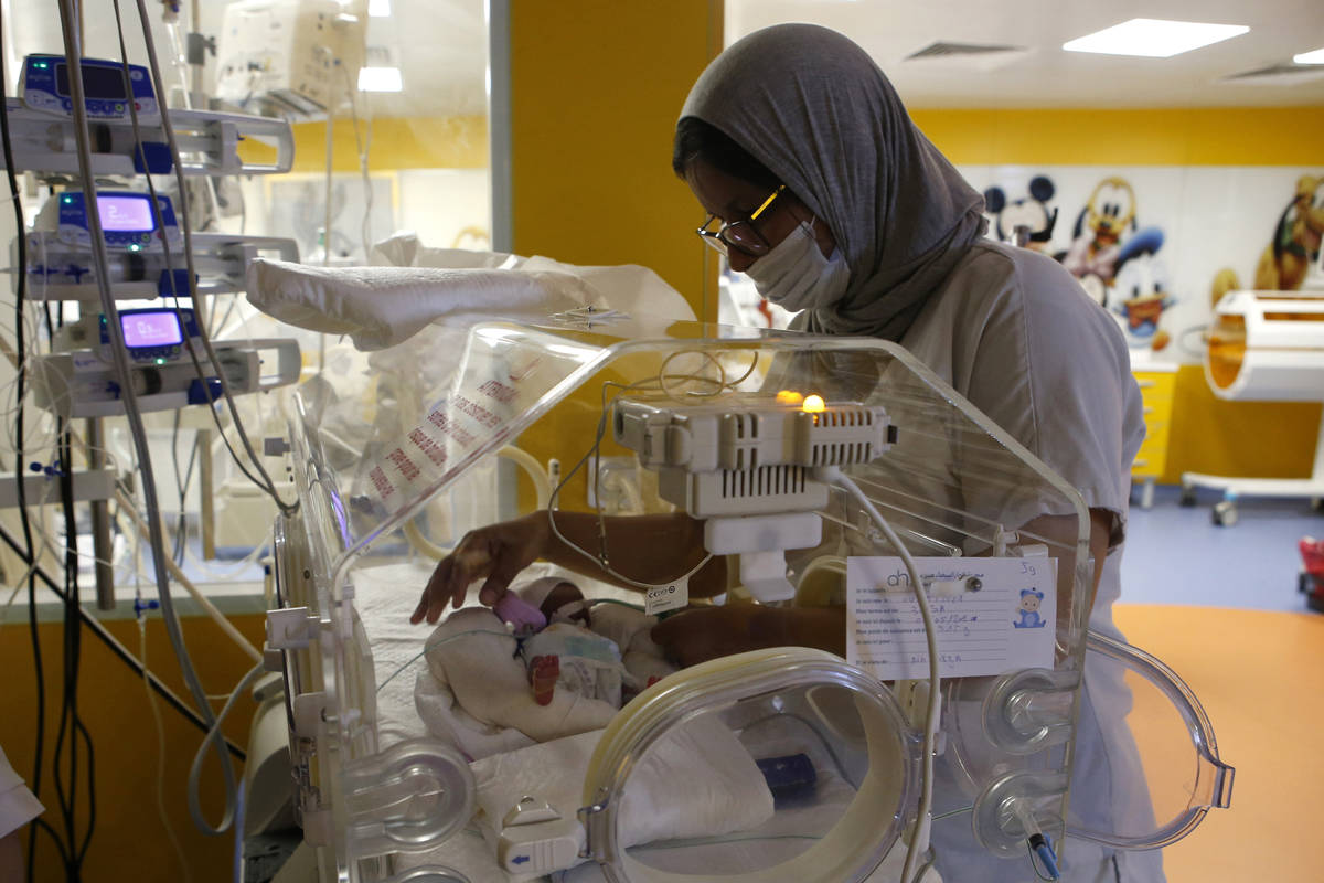 A Moroccan nurse takes care of one of the nine babies protected in an incubator at the maternit ...