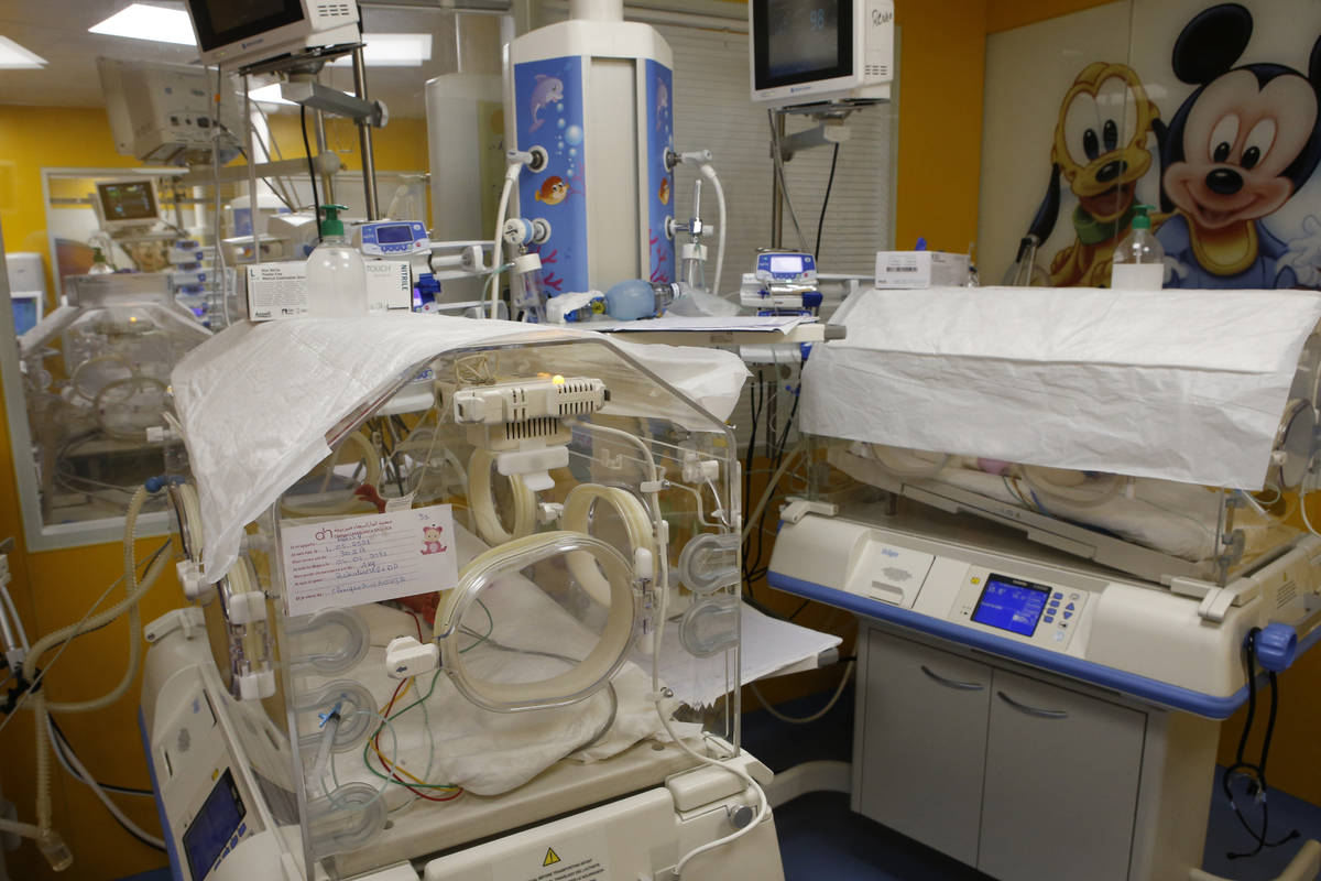 One of the nine babies rests in an incubator at the maternity ward of the private clinic of Ain ...