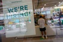 A signs announcing they are hiring hangs in the window of a restaurant in the Greenwich Village ...