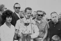 Bobby Unser is shown with the winner's trophy after taking the checkered flag at the 1968 Stard ...