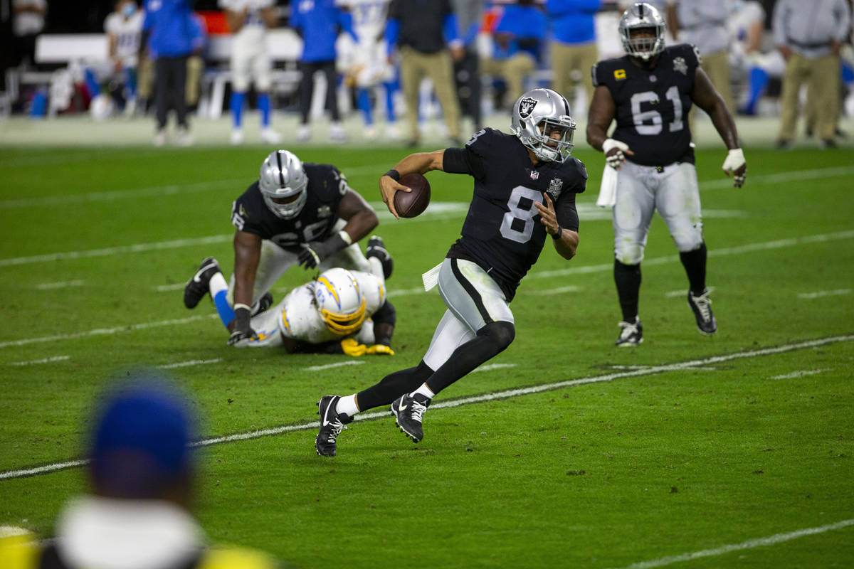 Raiders quarterback Marcus Mariota (8) rushes with the football during the fourth quarter of an ...