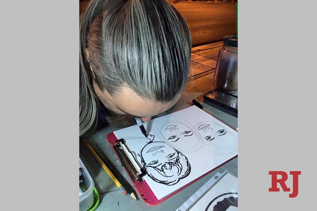 Larime Taylor works on a drawing in front of the Bellagio fountains in 2018. Taylor, who is dis ...