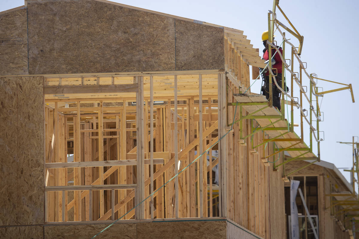 A construction worker build the roof of a home near W Elkhorn Road and N Aviary Way in North La ...