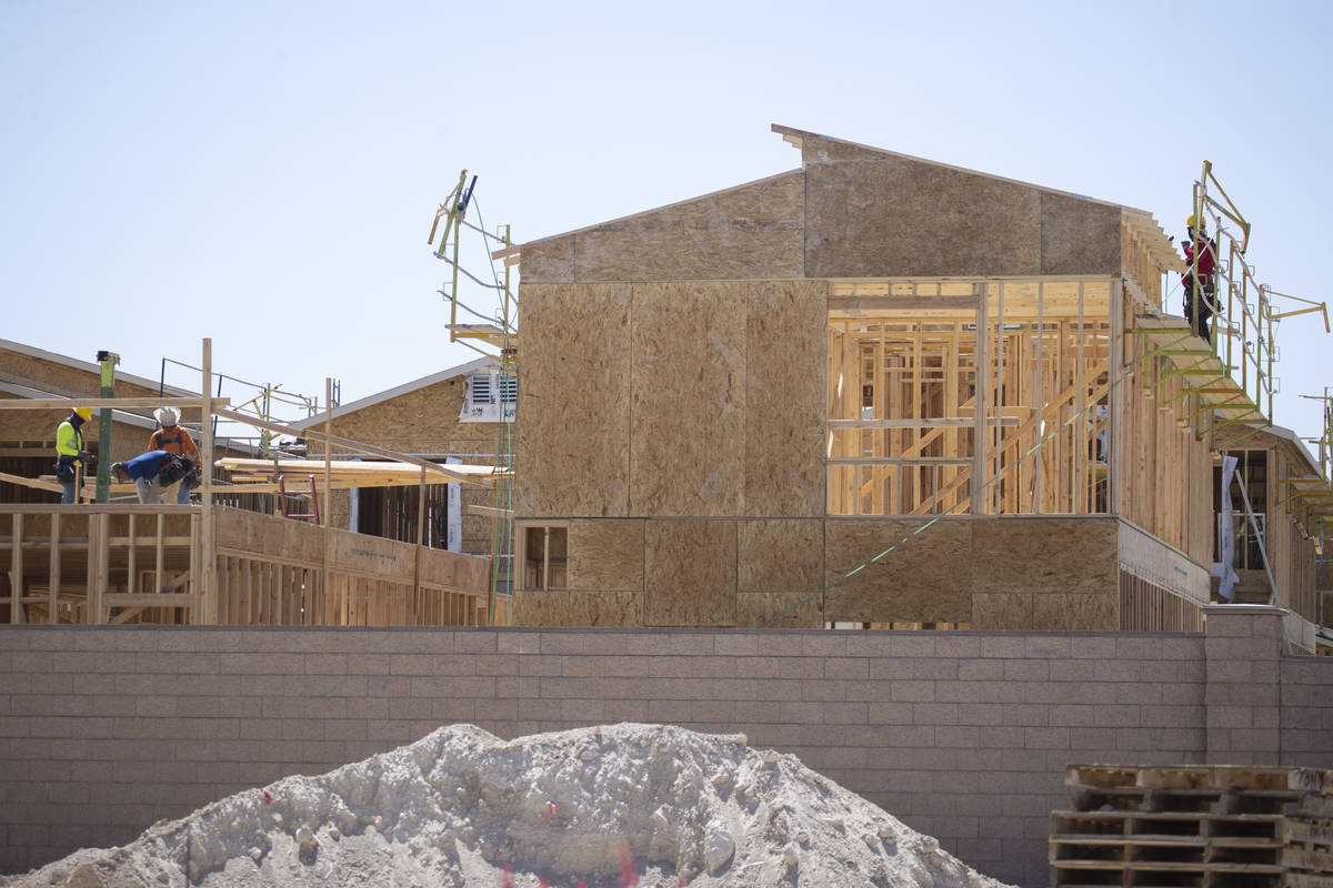 Construction workers build new homes near W Elkhorn Road and N Aviary Way in North Las Vegas, F ...