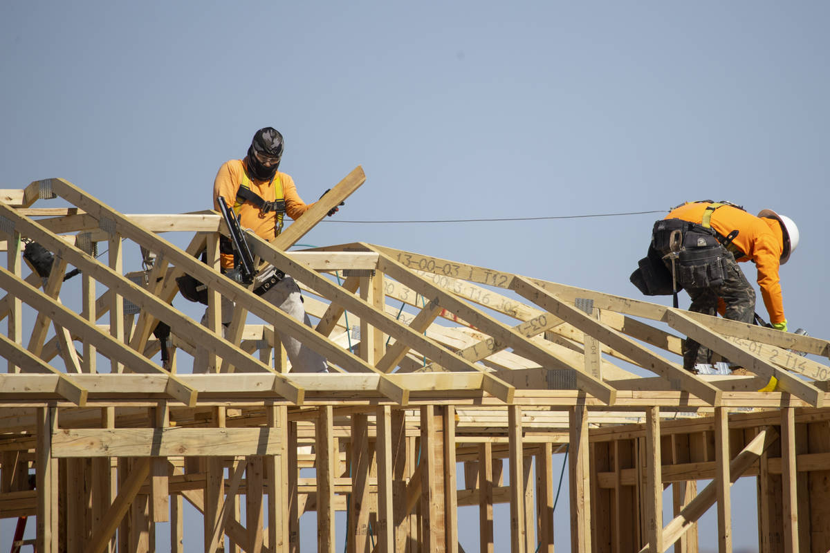 Construction workers build new homes near W Elkhorn Road and N Aviary Way in North Las Vegas, F ...