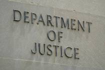 This May 4, 2021, photo shows a sign outside the Robert F. Kennedy Department of Justice buildi ...