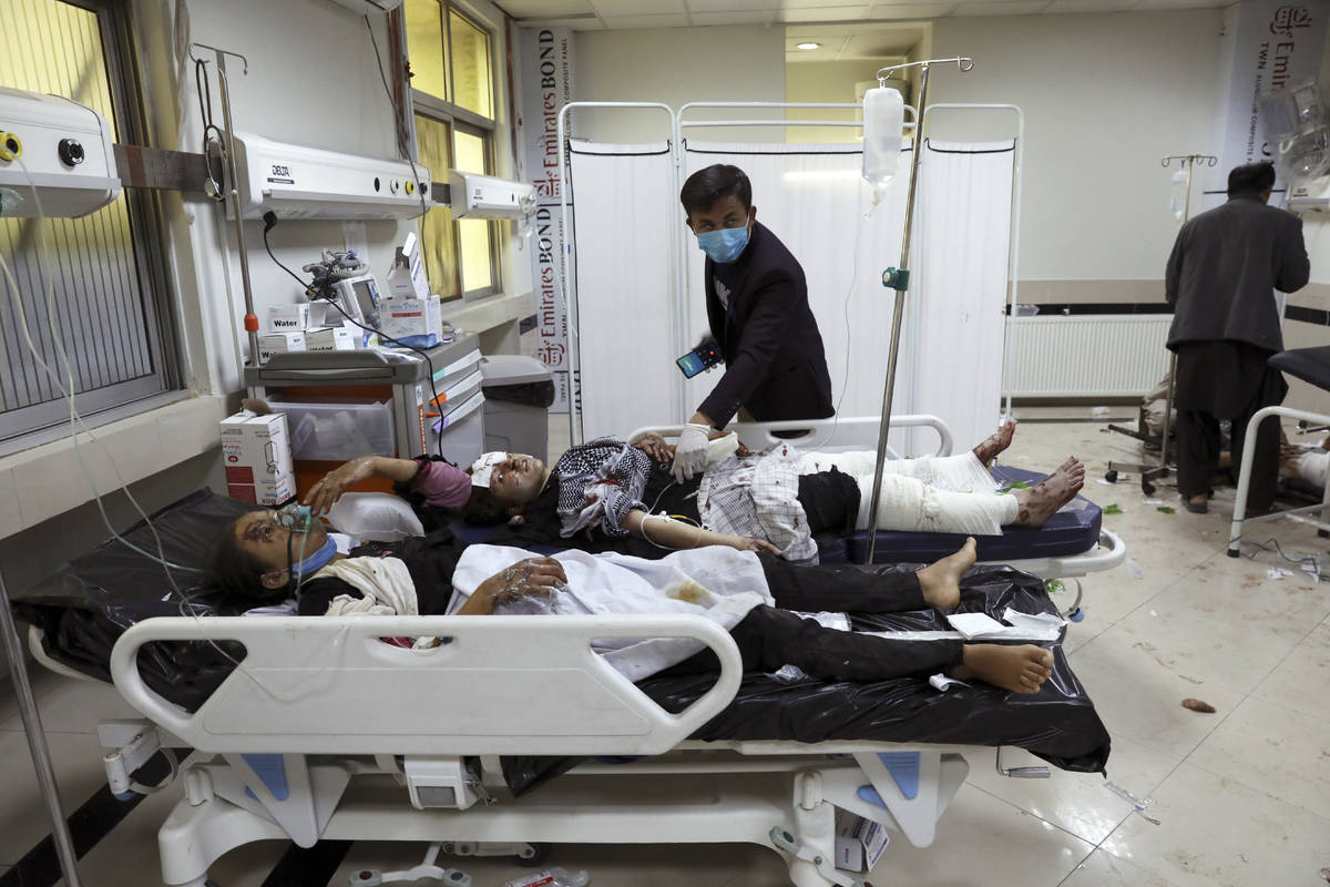 Afghan school students are treated at a hospital after a bomb explosion near a school in west o ...