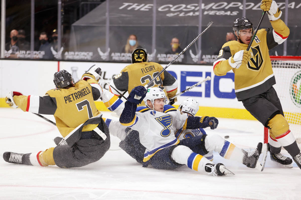 St. Louis Blues center Ivan Barbashev (49) and left wing Zach Sanford (12) take a fall with Veg ...