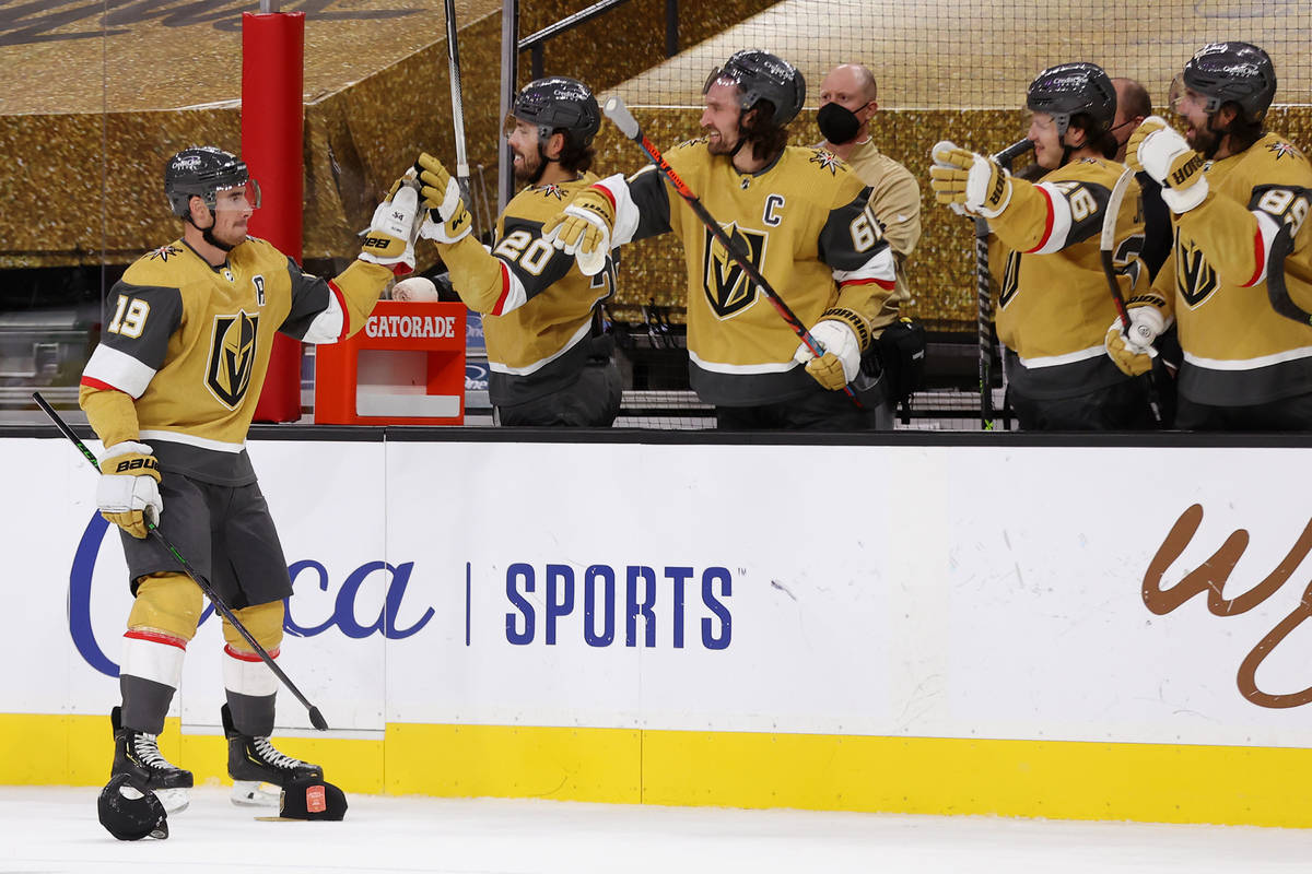 Vegas Golden Knights right wing Reilly Smith (19) high fives his team after his third goal agai ...