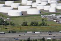 FILE - In this Sept. 8, 2008 file photo traffic on I-95 passes oil storage tanks owned by the C ...