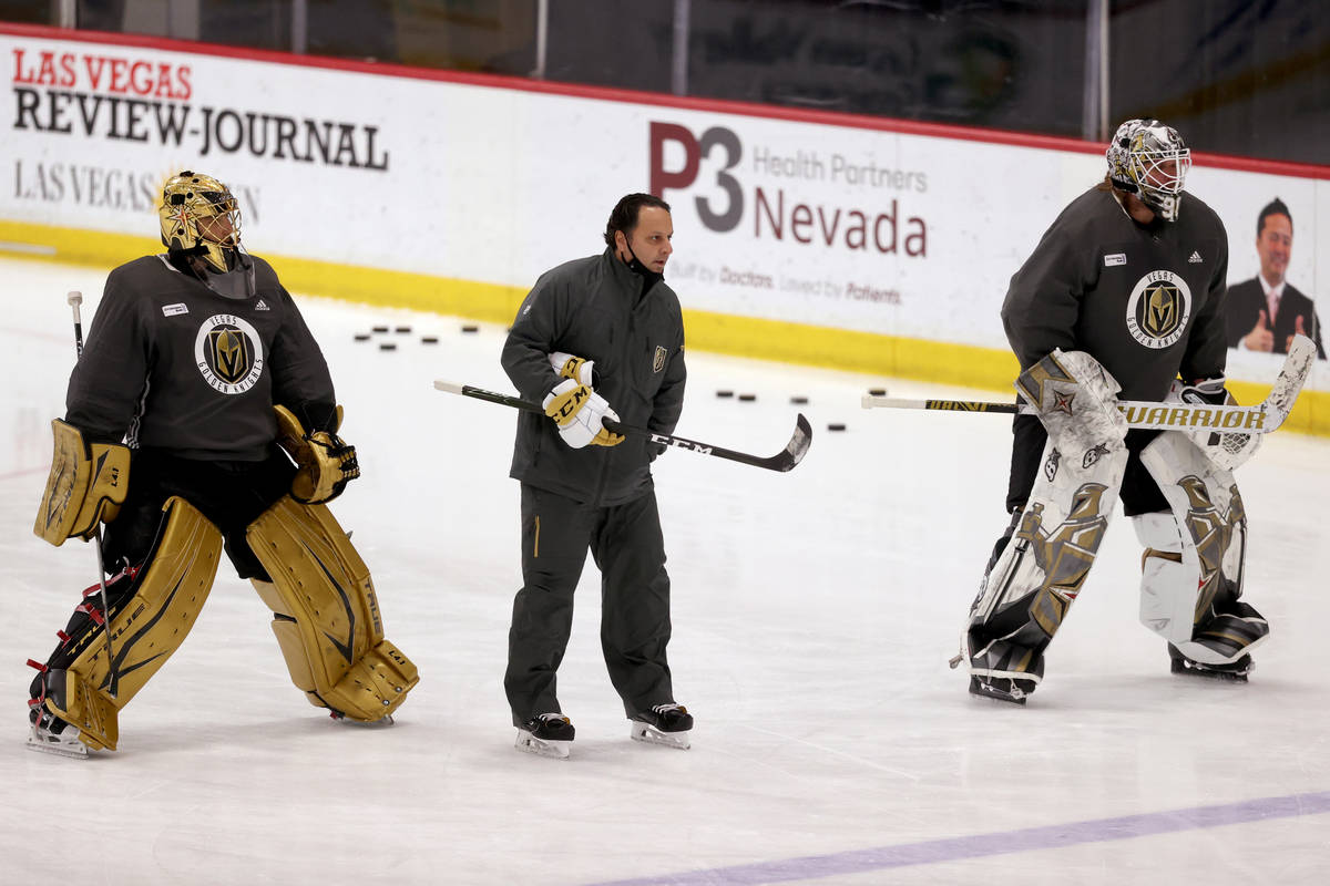 Golden Knights goaltenders Marc-Andre Fleury (29), left, and Robin Lehner (90) with coach Mike ...