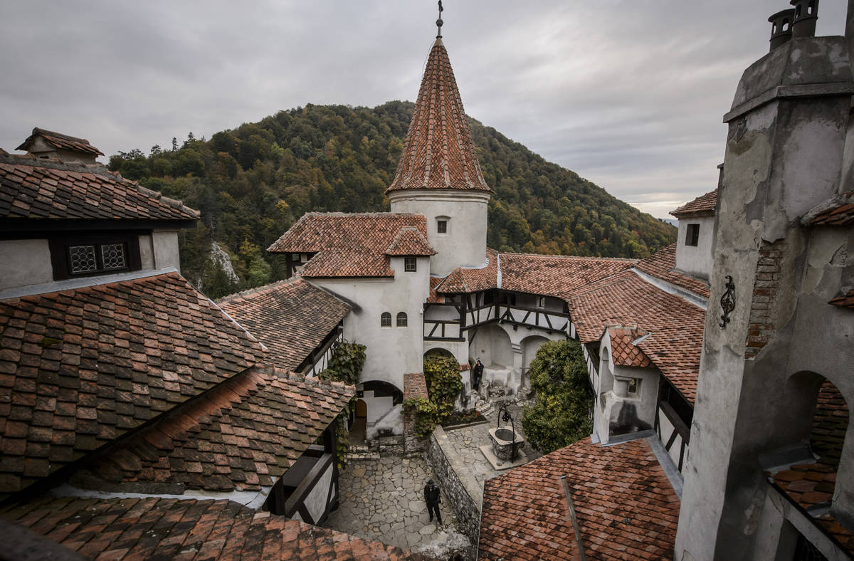 FILE - In this Oct. 9, 2016, file picture men stand in the inner courtyard of Bran Castle Roman ...