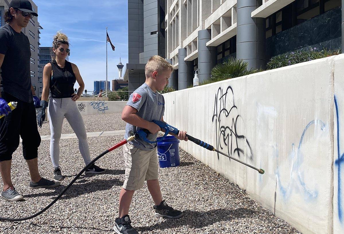 A group of volunteers on June 1, 2020, cleans up the defaced exterior of the Foley Federal buil ...
