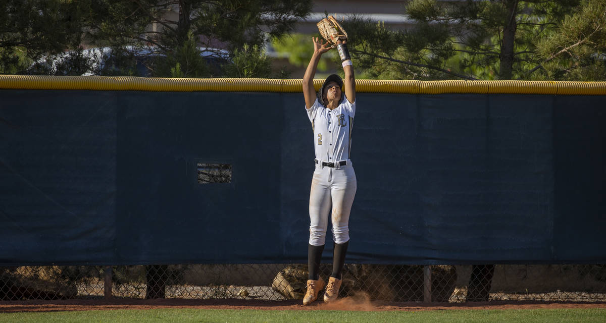 Faith Lutheran outfielder Ava Walker (2) extends up to grab a long fly ball against Centennial ...