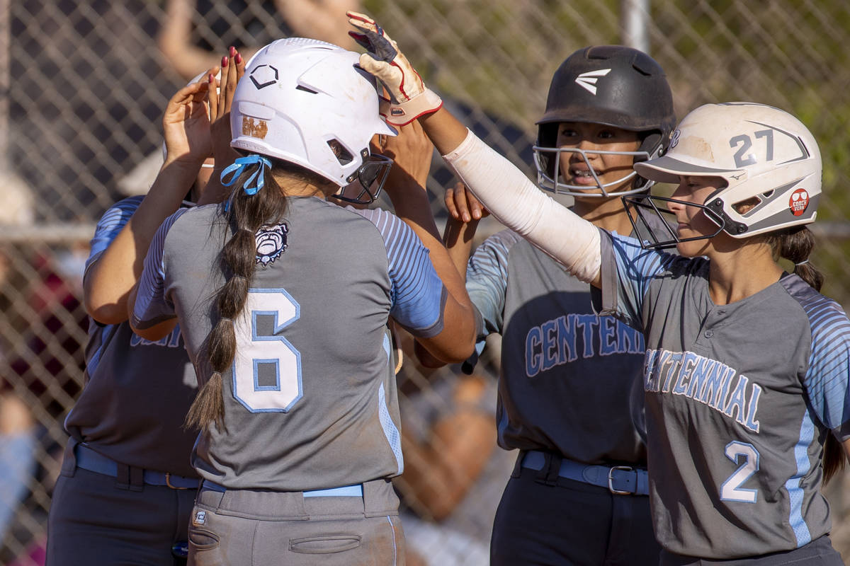 CentennialÕs Madison Lucero (6, left) is congratulated by teammates for a home run shot dr ...