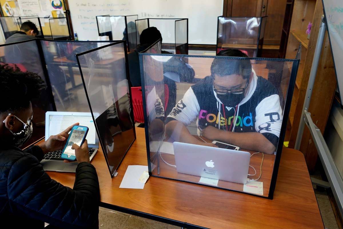 Senior Jose Solano-Hernandez, right, studies with classmates on the first day of in-person lear ...